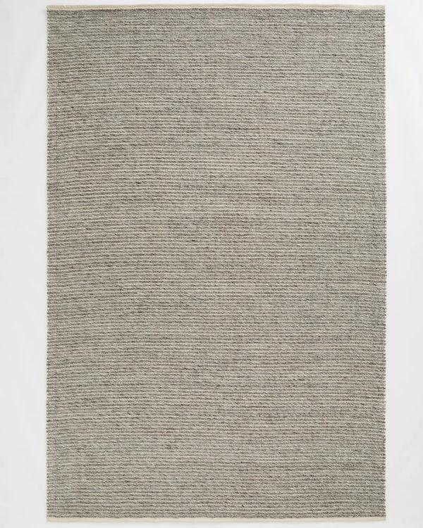 Andes Feather wool-cotton blend rug in soft grey, hand-woven with ribbed texture and cotton edging, by Weave Home