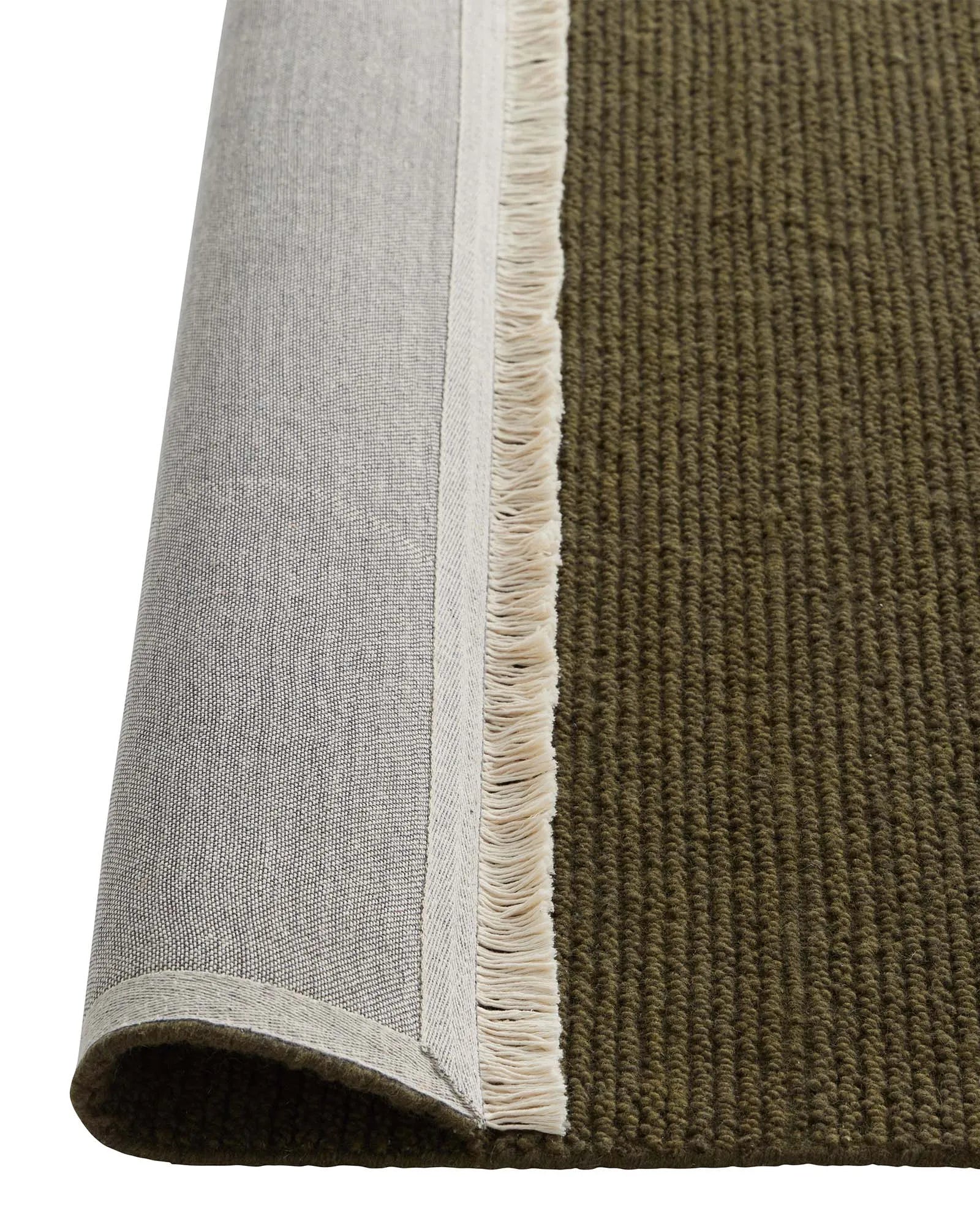 Fabien Moss rug detail showing ribbed wool weave texture with cream fringe edge by Weave Home