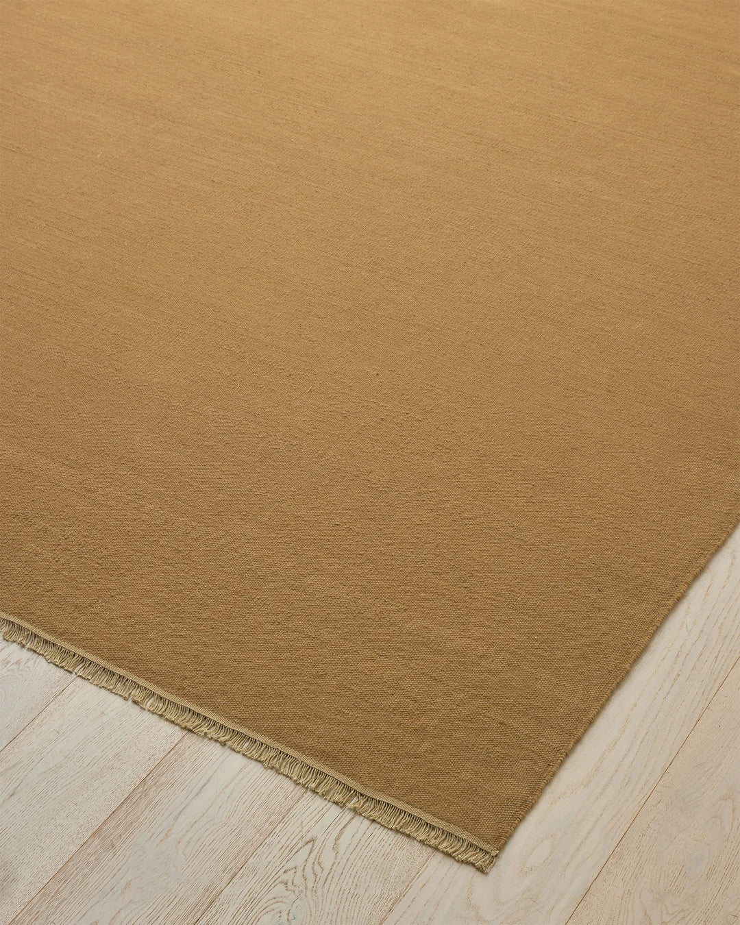 Jacqueline Brulee hand-woven wool rug in muted golden honey, flatweave construction with bound edge detail by Weave Home
