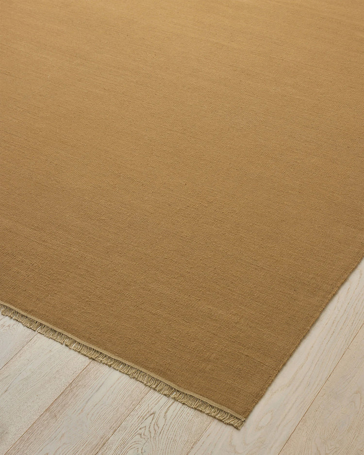 Jacqueline Brulee hand-woven wool rug in muted golden honey, flatweave construction with bound edge detail by Weave Home