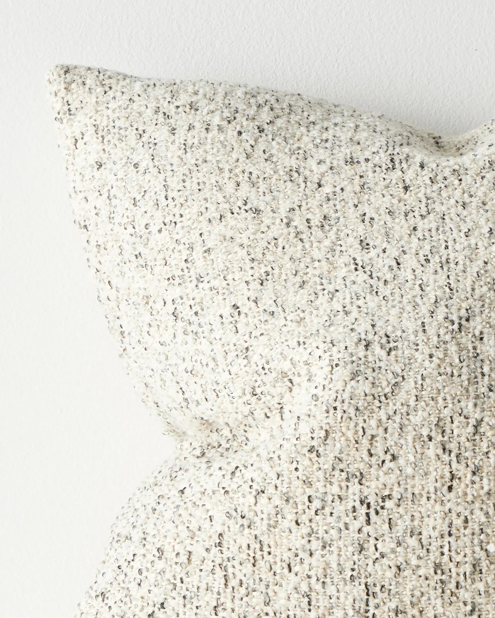 Lisette Polar 50x50 bouclé cushion cover close-up, twisted slub weave with charcoal and gold contrast on natural by Weave Home