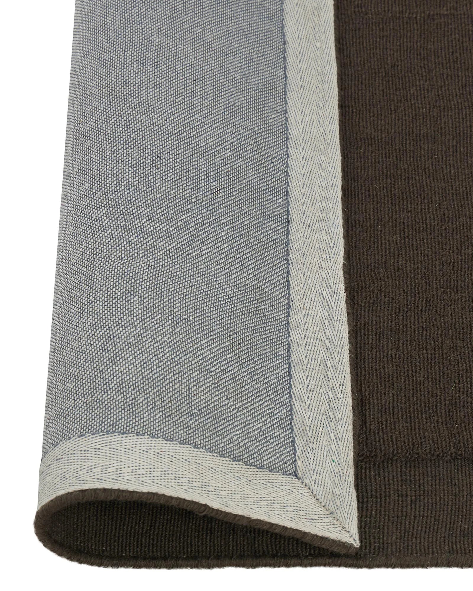 Cassio Fudge rug detail, dark mocha wool with serged edge and lowered border in cream, by Weave Home