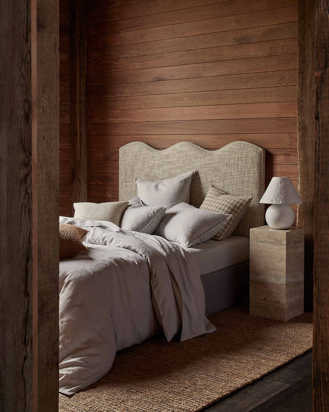 Ravello Flat Sheet in silver, European linen, styled with coordinating cushions on an upholstered bed by Weave Home