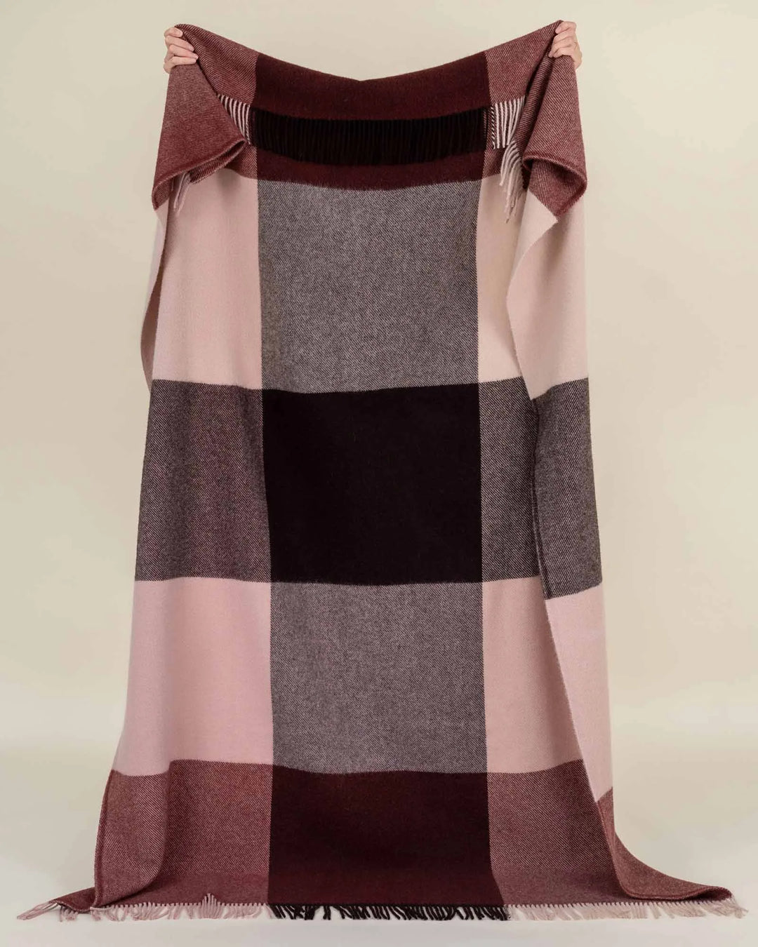 Syracuse Brookside Beetroot throw in berry, chocolate and pink large check pattern with fringe trim, held up by Weave Home