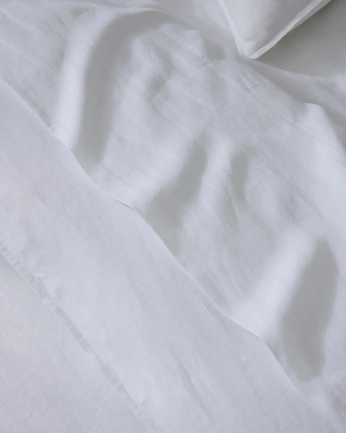 Ravello Flat Sheet in white European linen, close-up detail of soft woven texture and aero-finished fabric by Weave Home