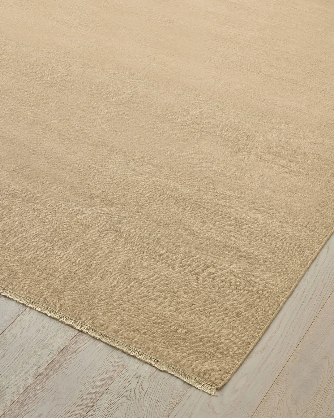 Jacqueline Barley high-traffic wool rug in soft sand, 3m x 4m, showing flatweave construction and fringe edge by Weave Home