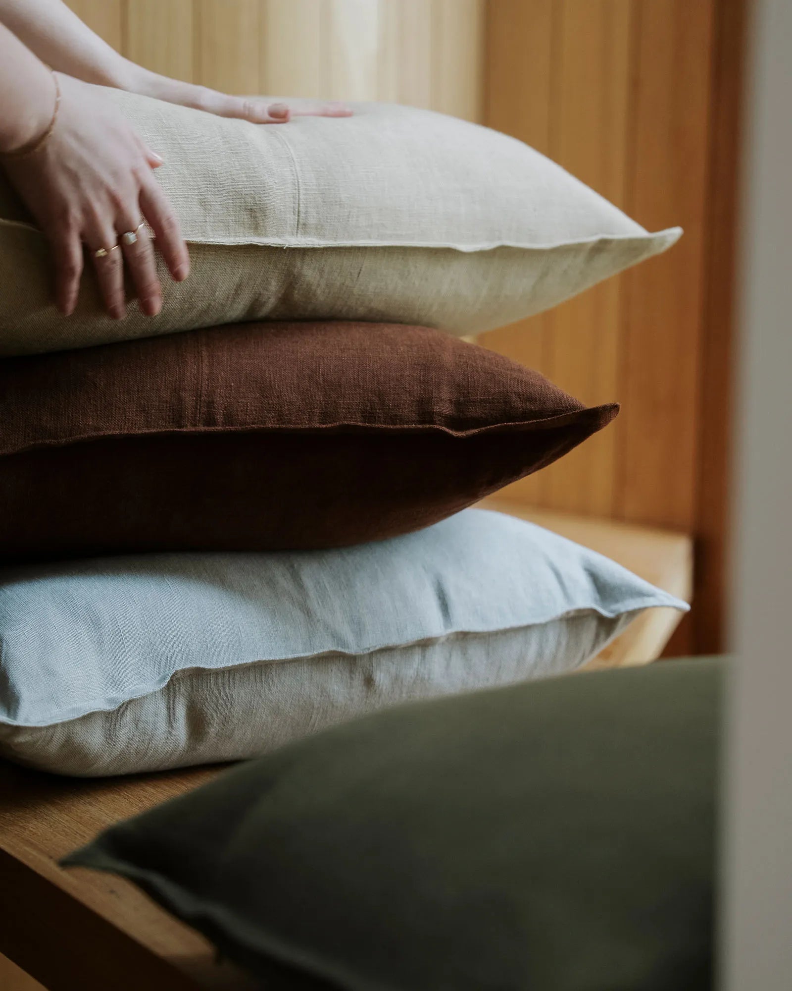 Como linen cushions in Horizon, oatmeal and henna stacked on timber, 100% European linen by Weave Home