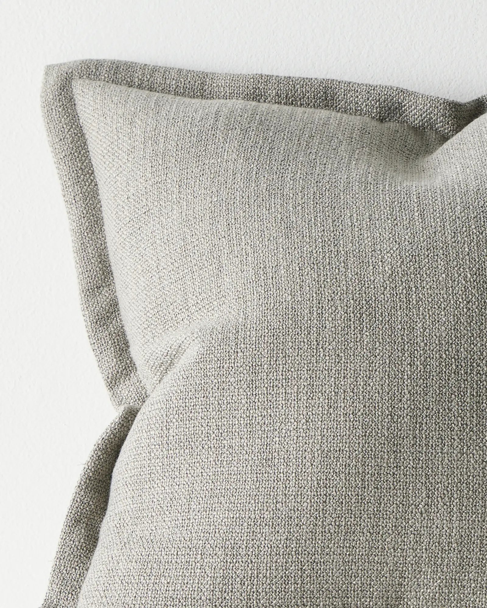 Figlio Fog 50x50 cushion cover detail, showing chunky woven polyester texture with piped edge seams by Weave Home