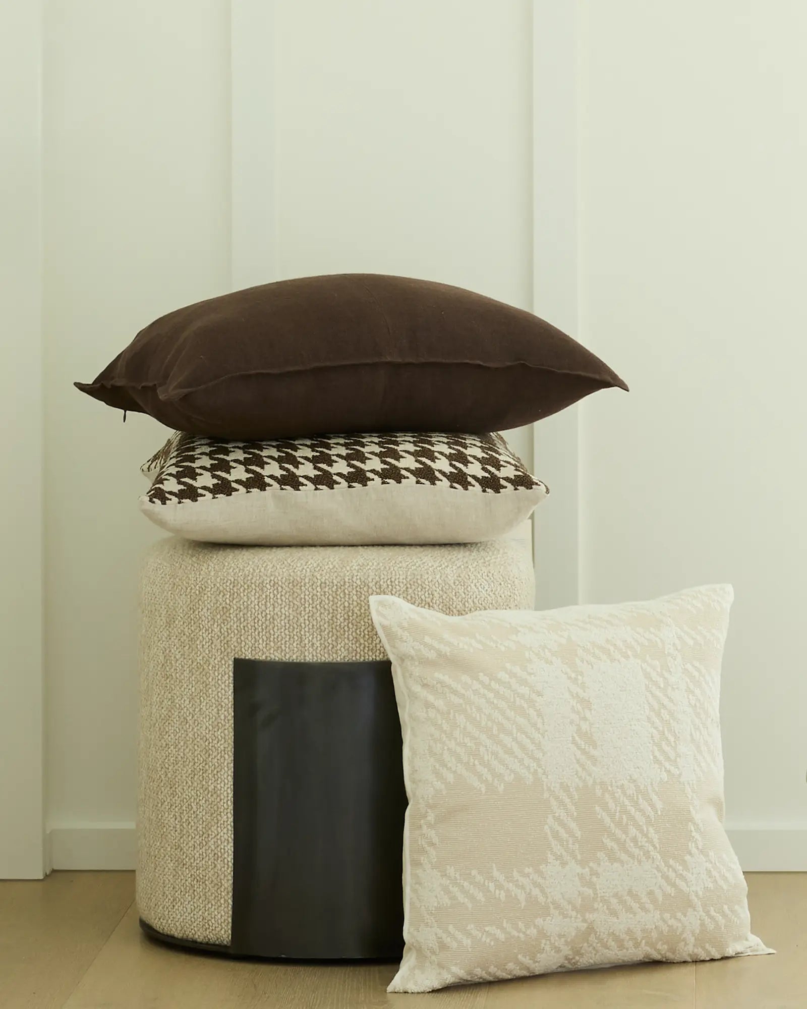 Como Cocoa cushion stack featuring chocolate brown linen, houndstooth pattern, and cream textures by Weave Home
