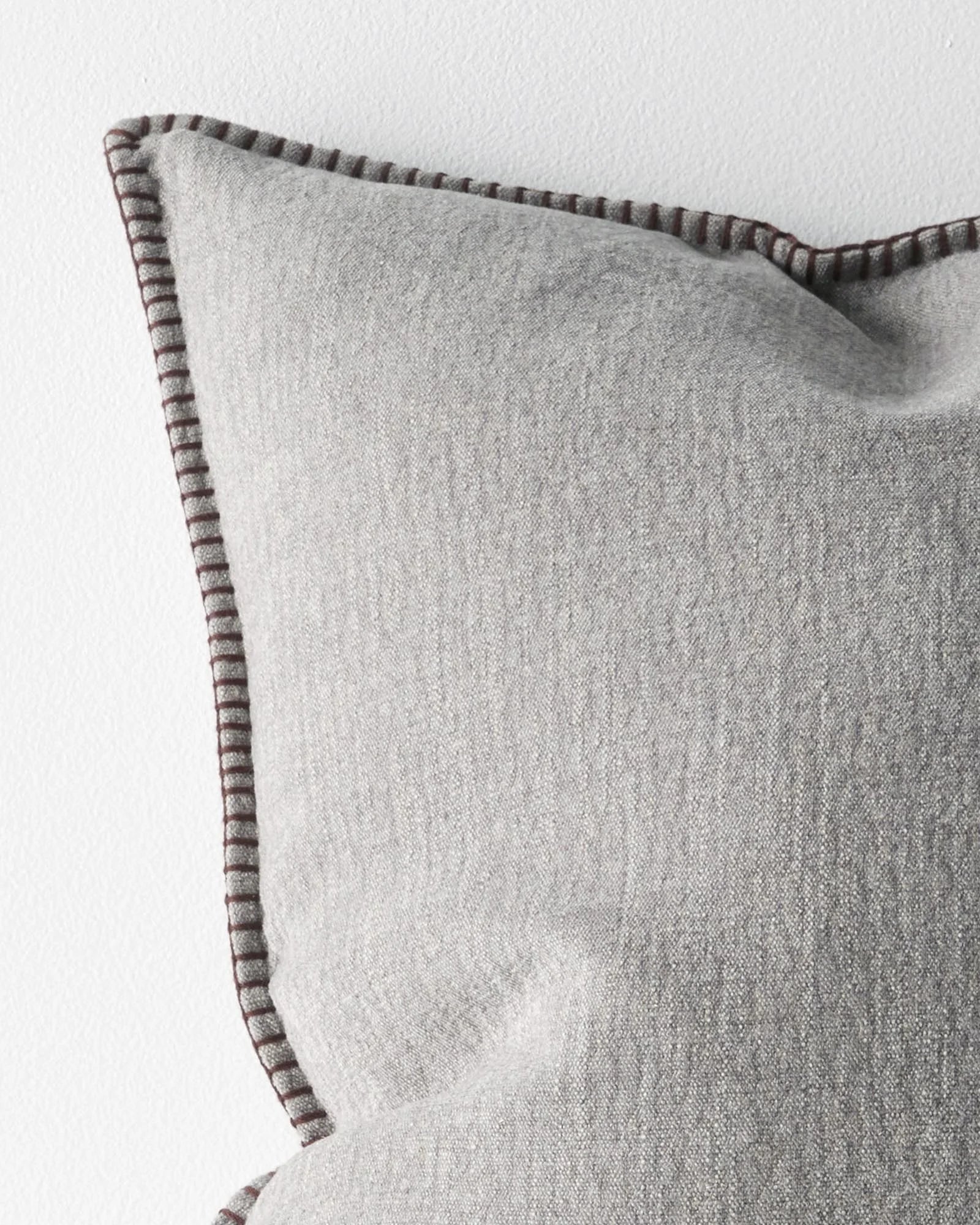 Alba Dove cushion detail, showing blanket stitch edge in contrasting burgundy thread on linen-polyester blend by Weave Home