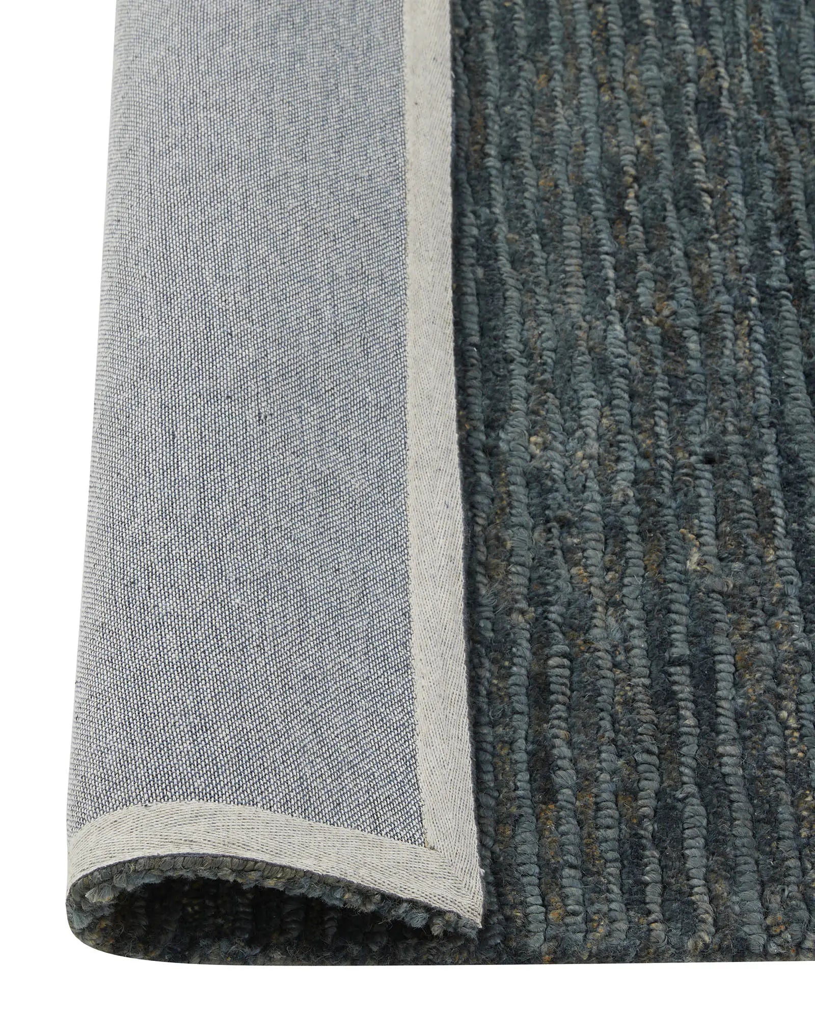 Bastian Dusk textured jute rug detail, showing looped and cut linear weave in charcoal blue with natural cream backing, by Weave Home