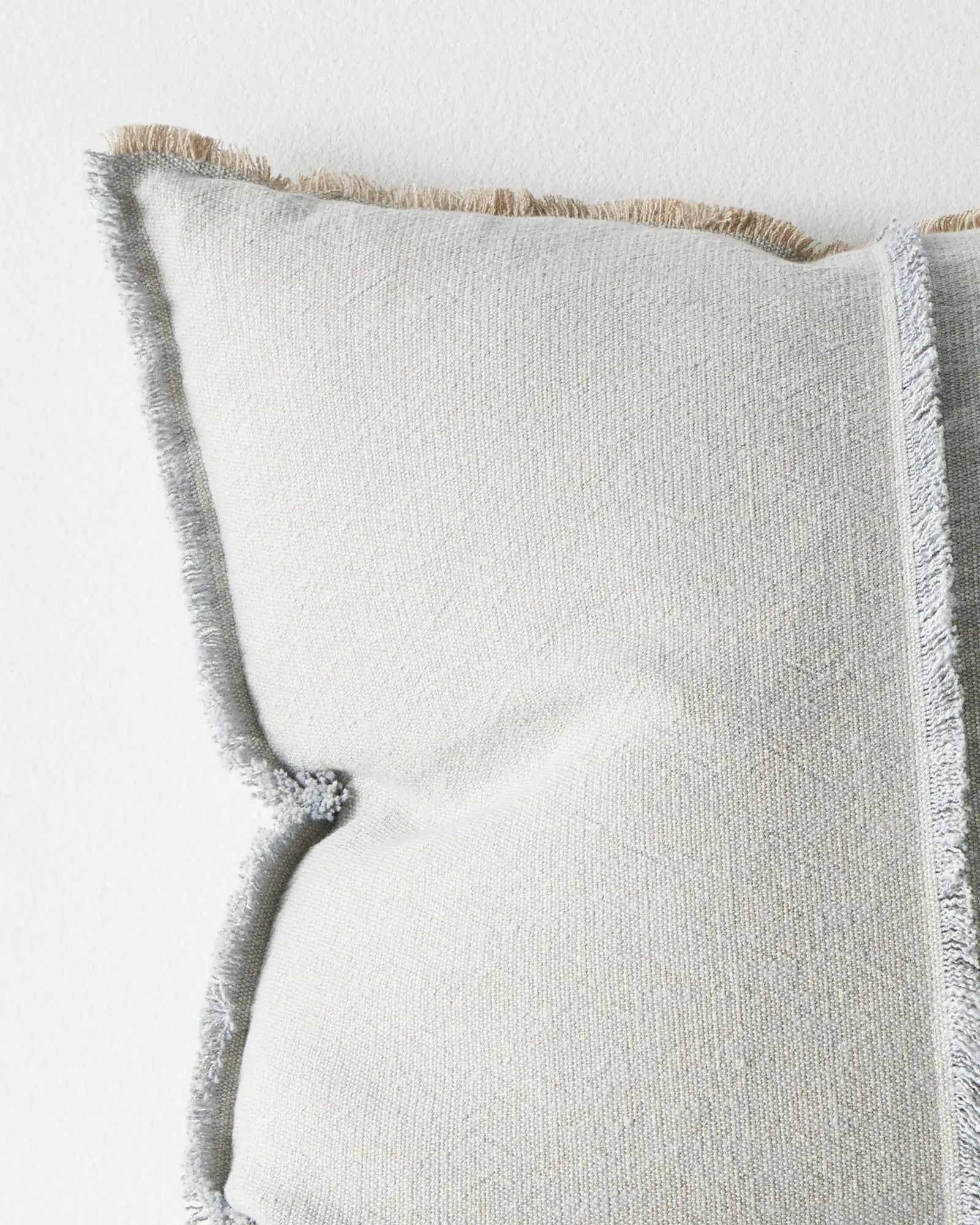 Adela Haze cotton linen cushion close-up, light blue with beige texture and raw-edge fringe by Weave Home