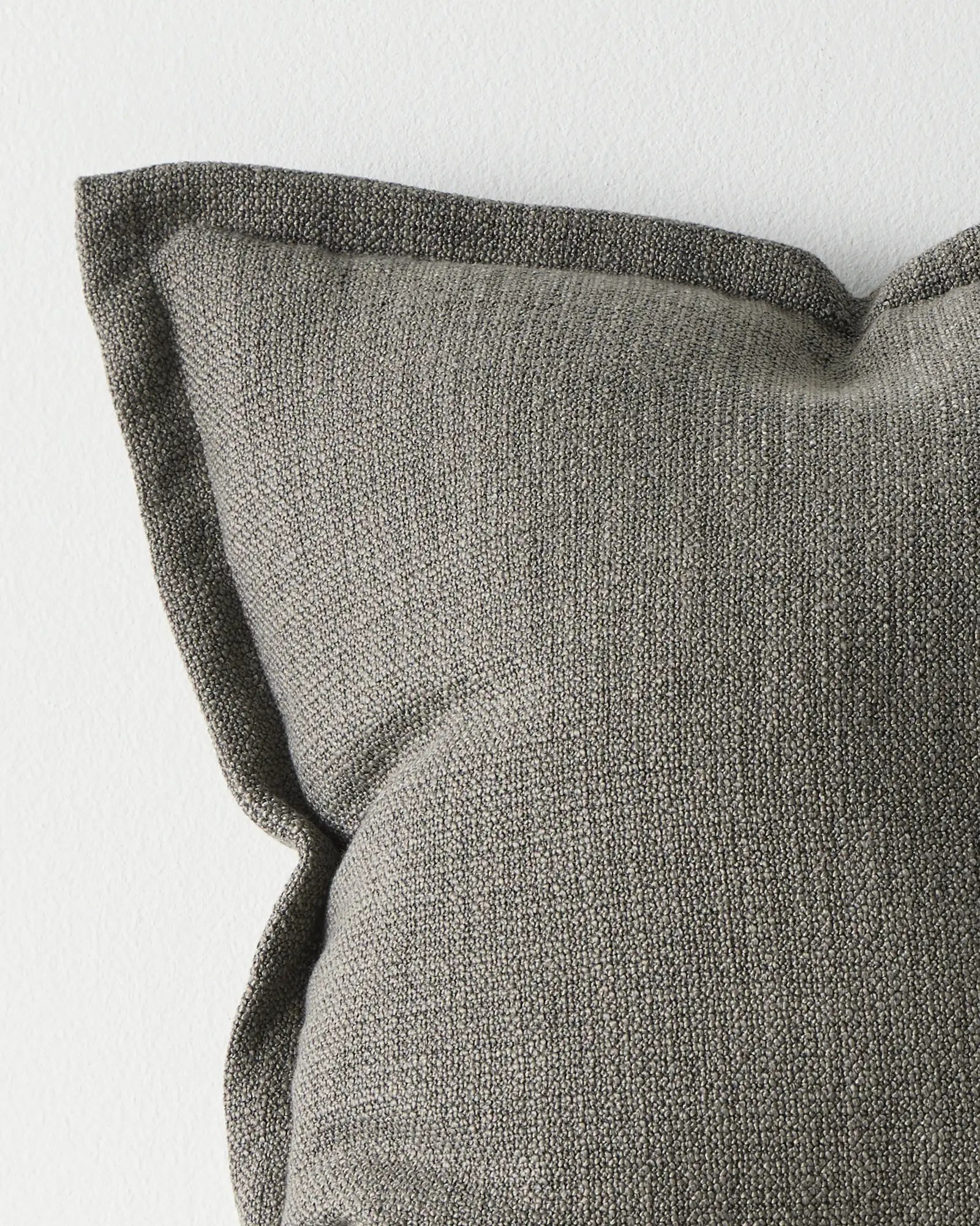 Figlio Graphite cushion 50x50cm, close-up of chunky woven polyester texture in medium grey with tailored piping edge by Weave Home