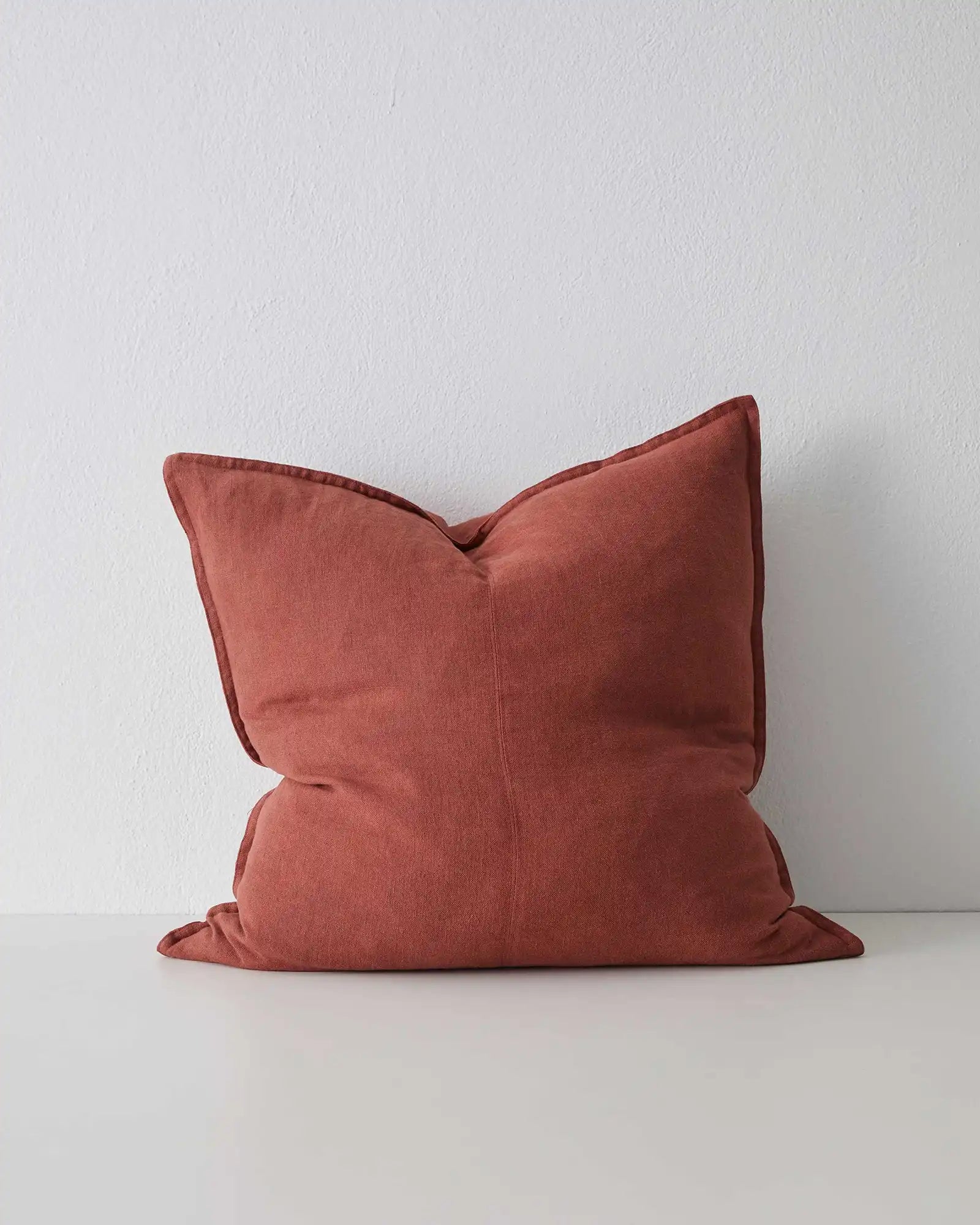 Como Sienna 60x60 linen cushion in burnt red, stonewashed European linen with tailored piping detail by Weave Home