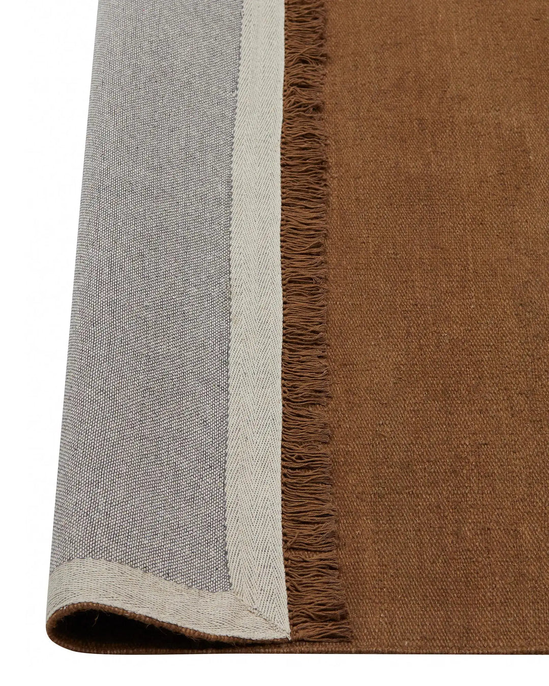 Emilio Toffee linen rug detail, showing flat-weave construction with fringe border and warm golden brown finish by Weave Home