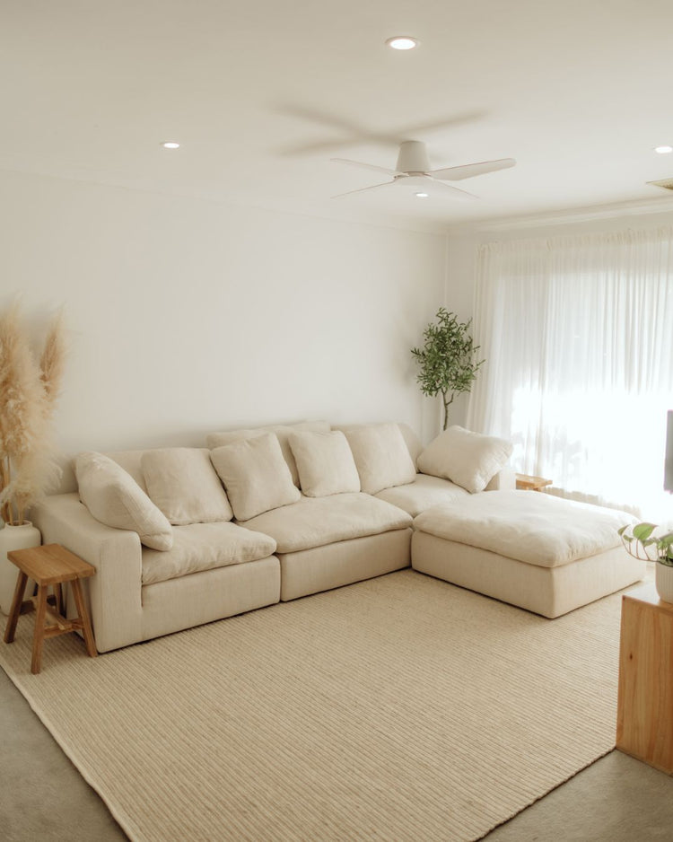 Andes Sandstorm wool-cotton rug in cream with ribbed texture and cotton edging, styled in modern living room by Weave Home