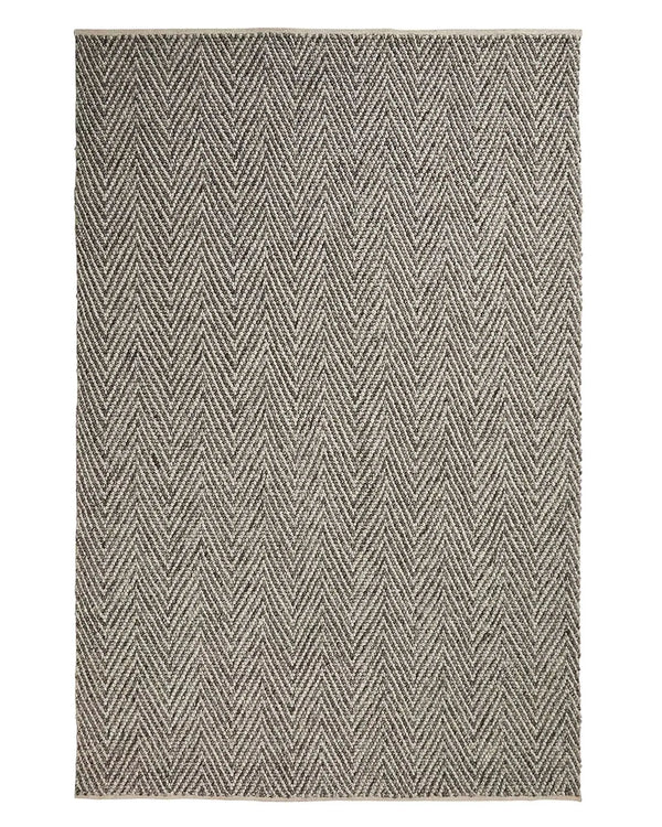 Zambesi Feather 2x3m wool blend rug in soft grey, featuring tightly woven chevron pattern with cotton braided edge by Weave Home