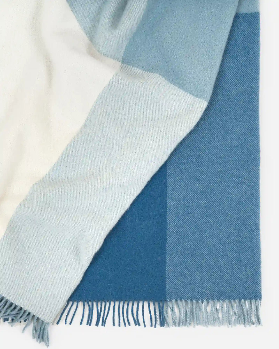 Bayswater Breeze wool throw in blue and white colorblock with fringed edge, detail view by Weave Home