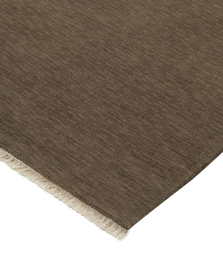Alessandre Taupe low-traffic rug in NZ wool with natural fringe edge, showing textured weave detail by Weave Home
