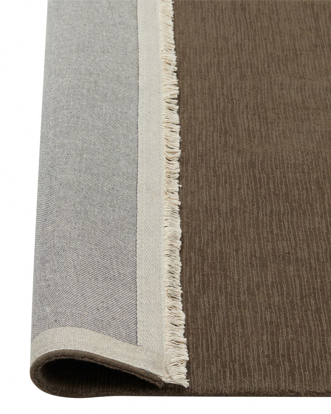 Alessandre Taupe rug detail showing hand-woven NZ wool with fringed border and cotton backing by Weave Home