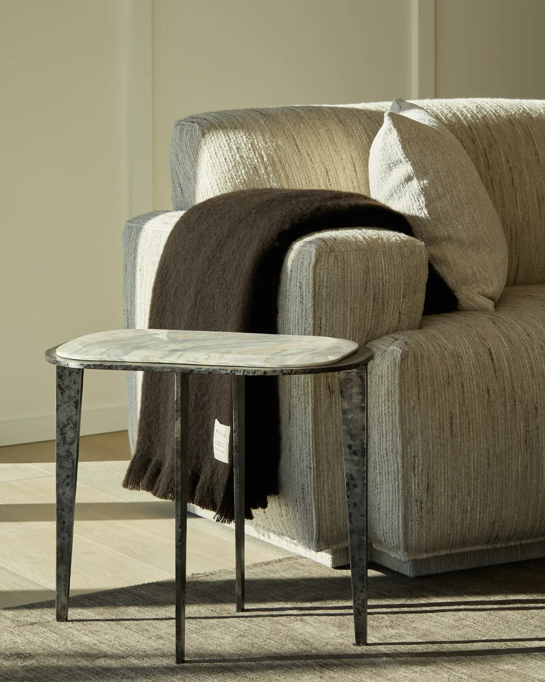 Hyde Cocoa wool blend throw in rich dark chocolate, draped over modern chair with brushed plush finish by Weave Home