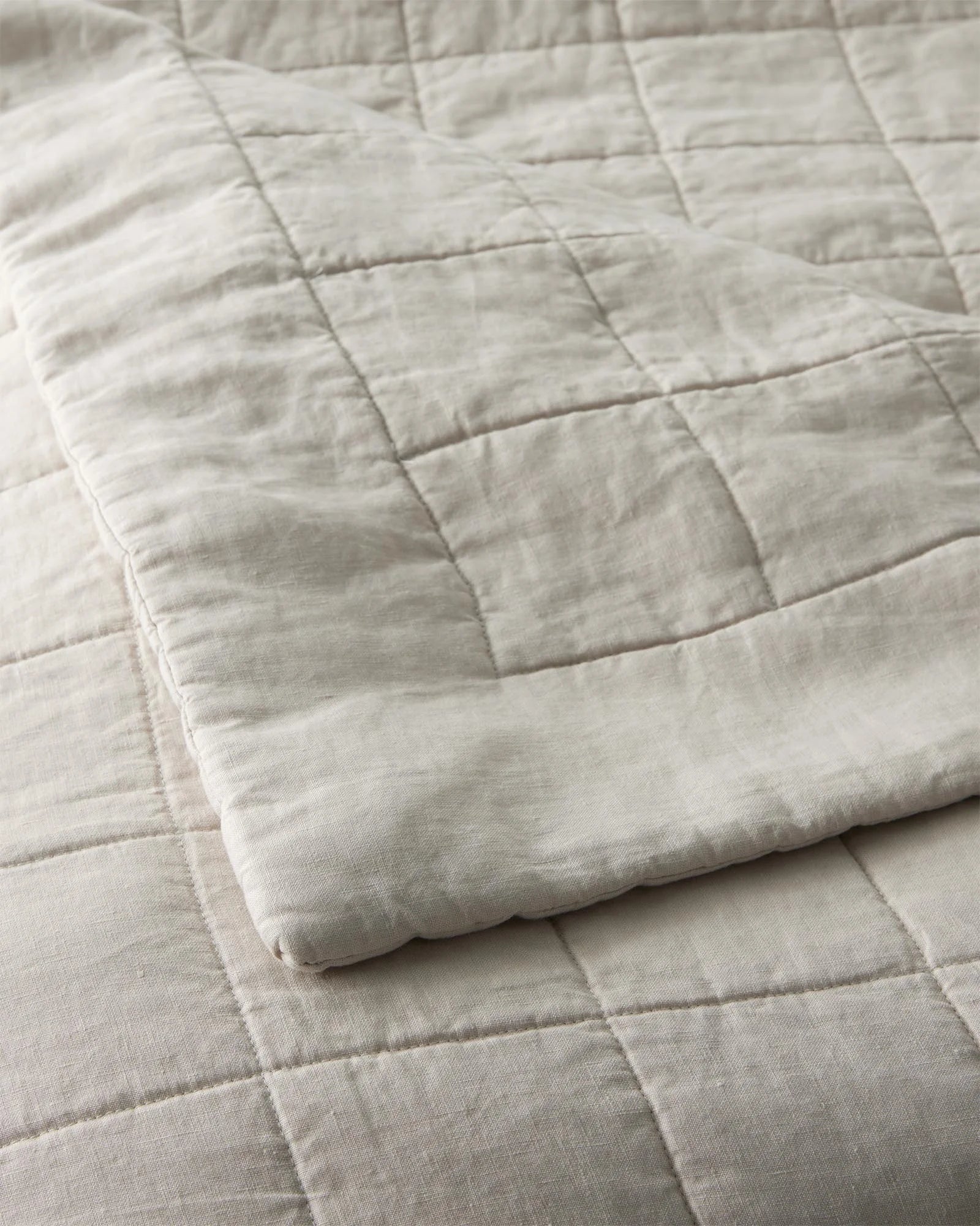 Ravello Coverlet in Bone, detail view of European linen with box quilt stitching and cotton-poly fill by Weave Home