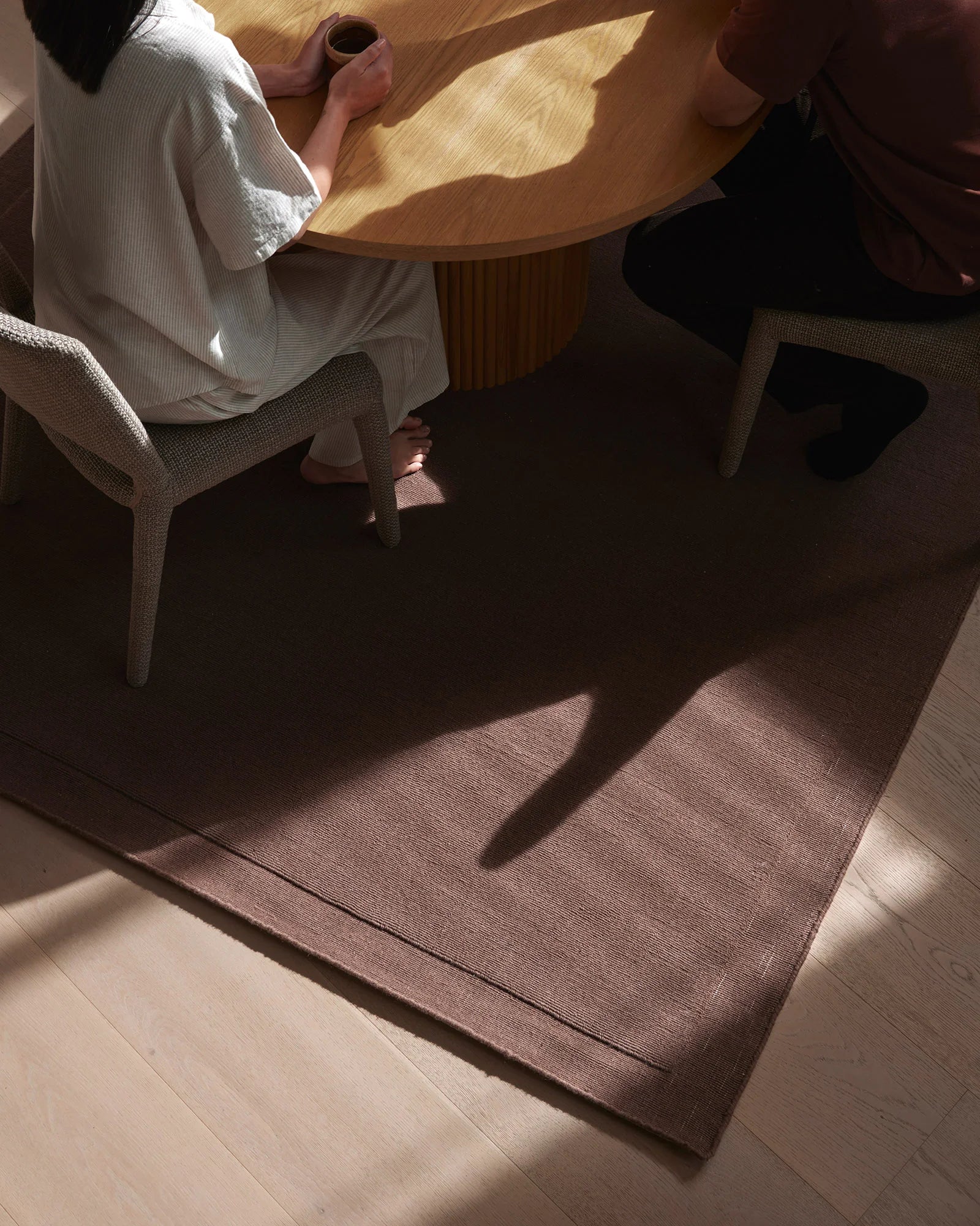 Cassio Mulberry high-traffic NZ wool rug with serged edge, styled in living space by Weave Home
