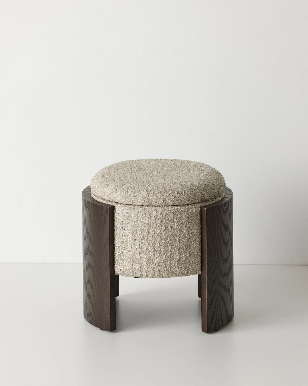 Norcia Stone bouclé ottoman with textured cream upholstery and dark walnut wood panel legs, featuring hidden storage by Weave Home