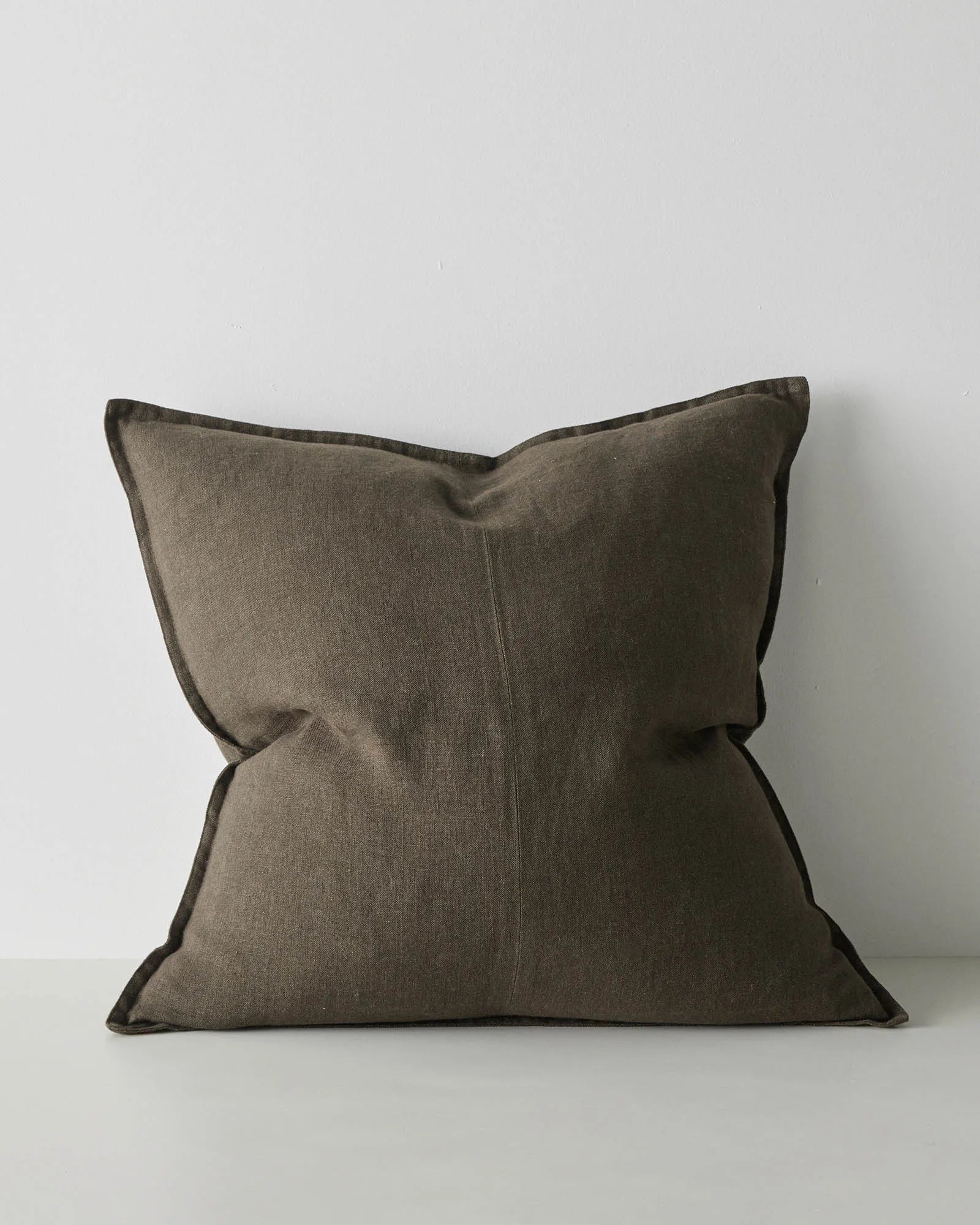 Como Spruce 60x60 cushion in dark green European linen with double-stitch French seam edge detail by Weave Home