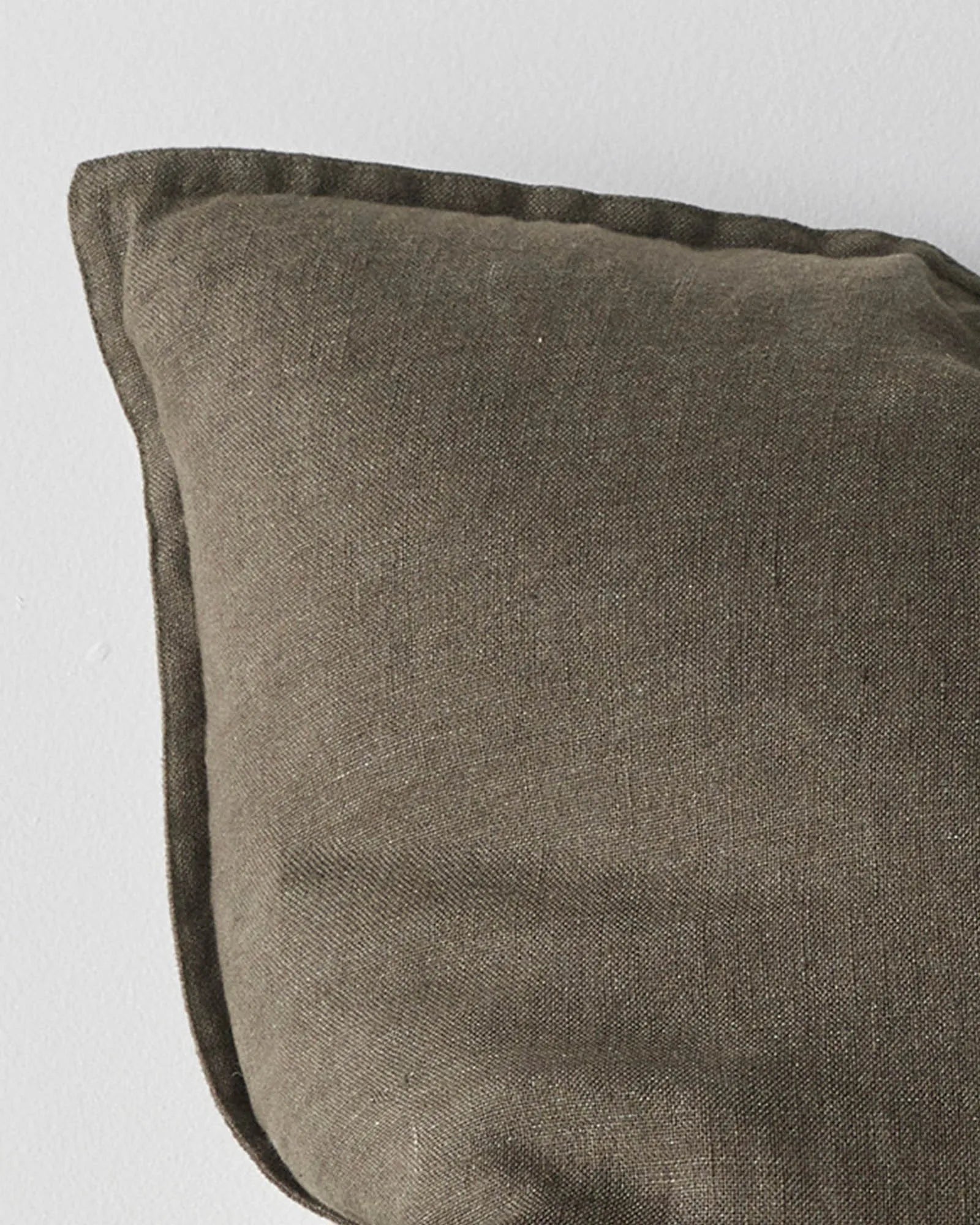 Como Spruce cushion, close-up view showing stonewashed European linen texture and double-stitch French seam edge detail by Weave Home