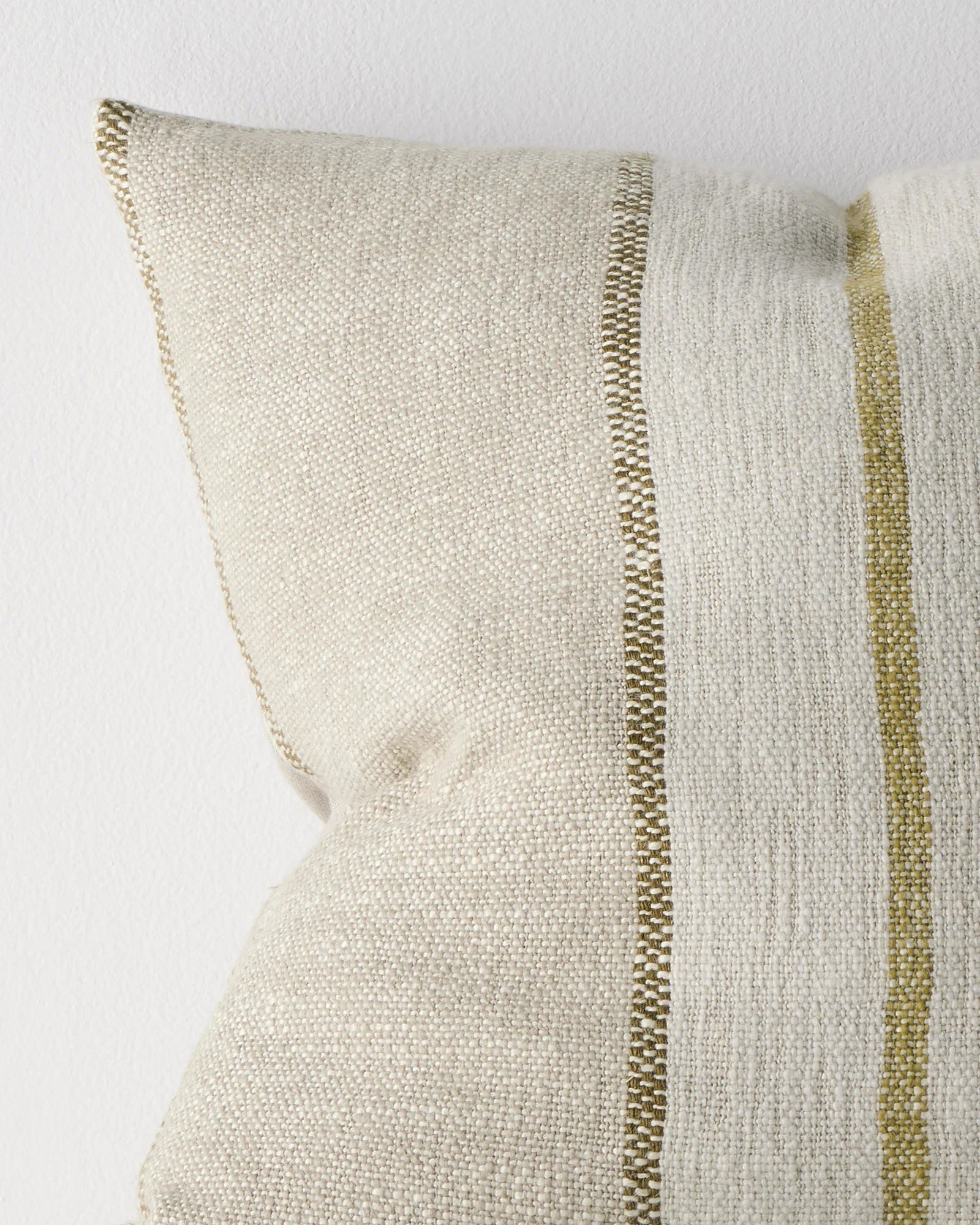 Ottavio Willow cushion close-up detail showing chunky slub weave with olive and lime striped piping against cream linen polyester blend by Weave Home