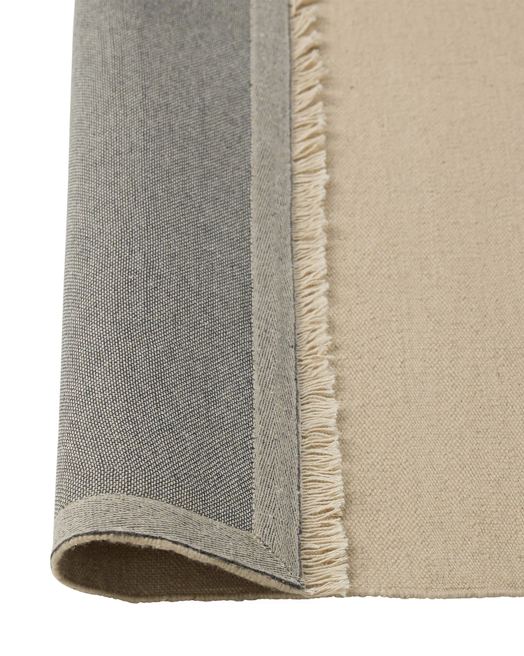 Jacqueline Cashew flatweave wool rug detail, showing fringe border and tonal neutral weave by Weave Home