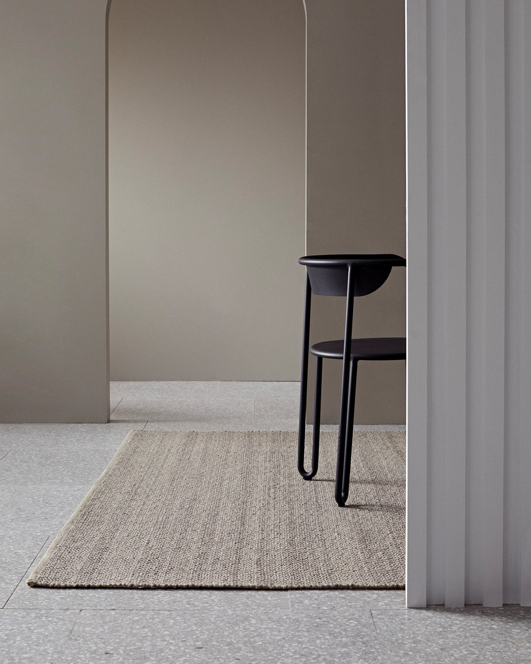 Andes Feather hand-woven wool cotton rug in natural beige with ribbed texture, styled in modern interior space by Weave Home