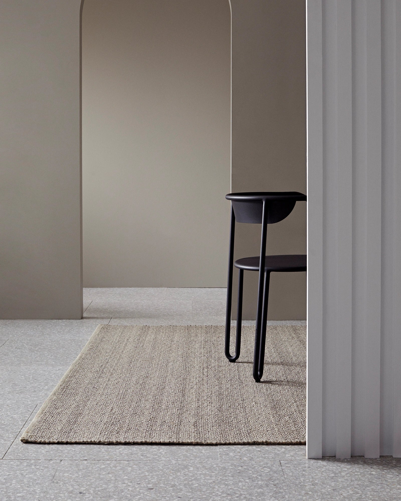 Andes Feather hand-woven wool cotton rug in natural beige with ribbed texture, styled in modern interior space by Weave Home