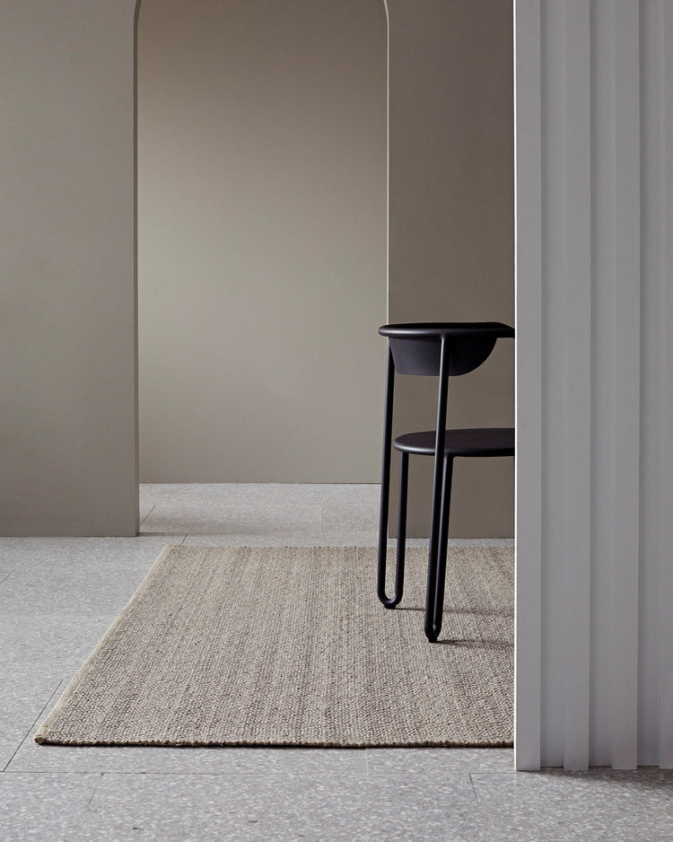 Andes Feather hand-woven wool cotton rug in natural beige with ribbed texture, styled in modern interior space by Weave Home