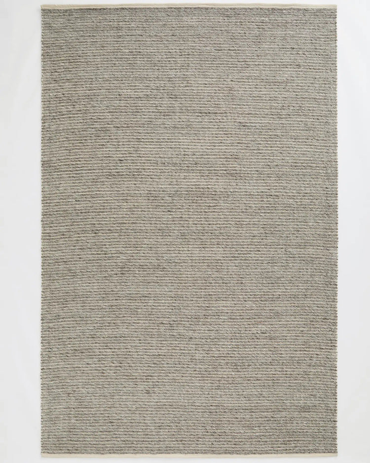 Andes Feather wool-cotton blend rug in soft grey, hand-woven with ribbed texture and cotton edging, by Weave Home