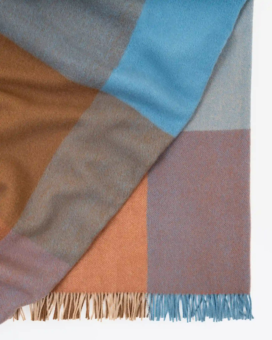 Brookside Ocean throw detail showing woven wool in cornflower blue, rust, oak and tan with fringe trim by Weave Home
