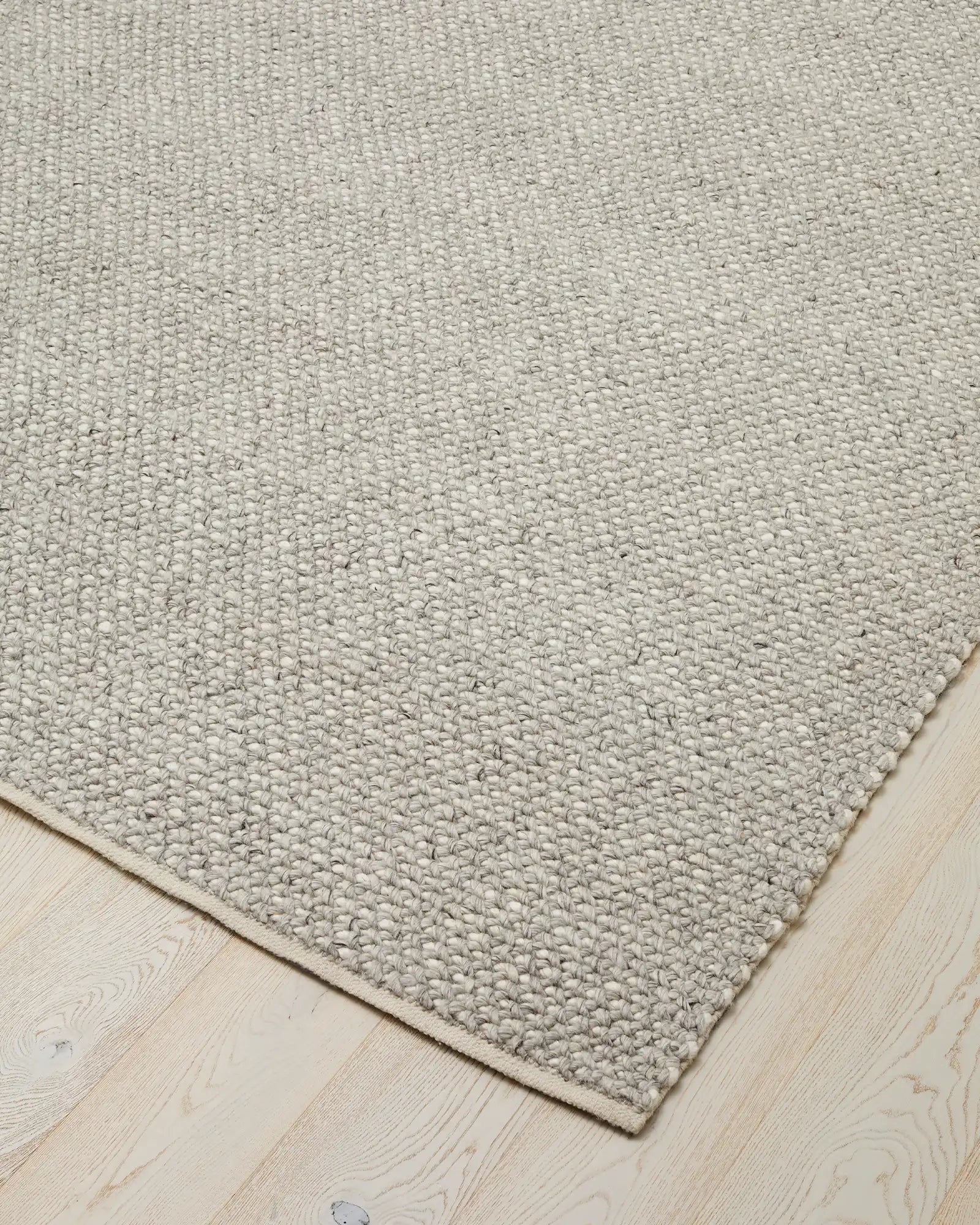 Emerson Feather rug corner detail, hand-woven NZ wool and viscose with chunky textured weave in soft cream tone by Weave Home