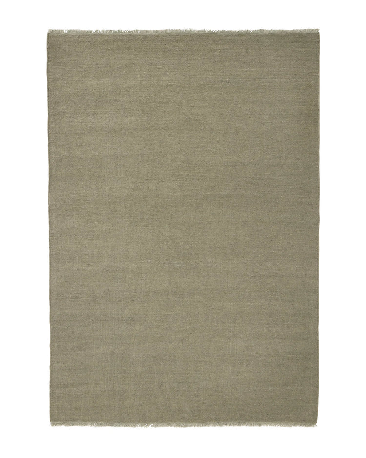 Jacqueline Pumice rug in soft taupe grey with sage green undertones, flatweave wool construction with raw fringe border by Weave Home