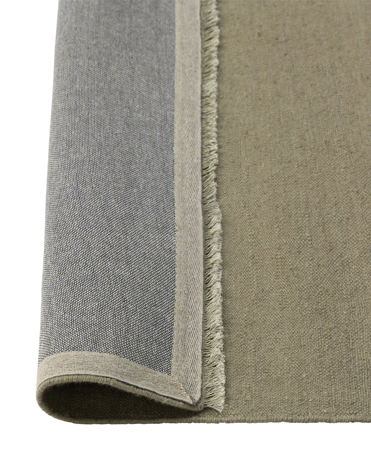 Jacqueline Pumice wool rug detail, showing flatweave construction with fringed edge and taupe-grey colorway by Weave Home