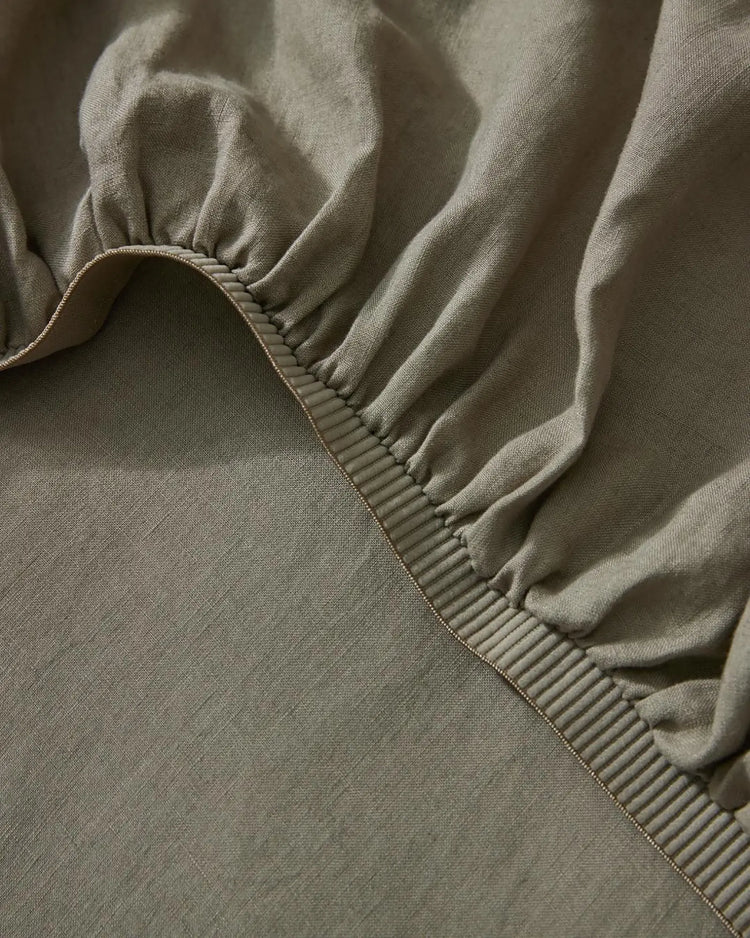 Ravello Fitted Sheet in caper, detail view of elastic binding and stitched seam by Weave Home