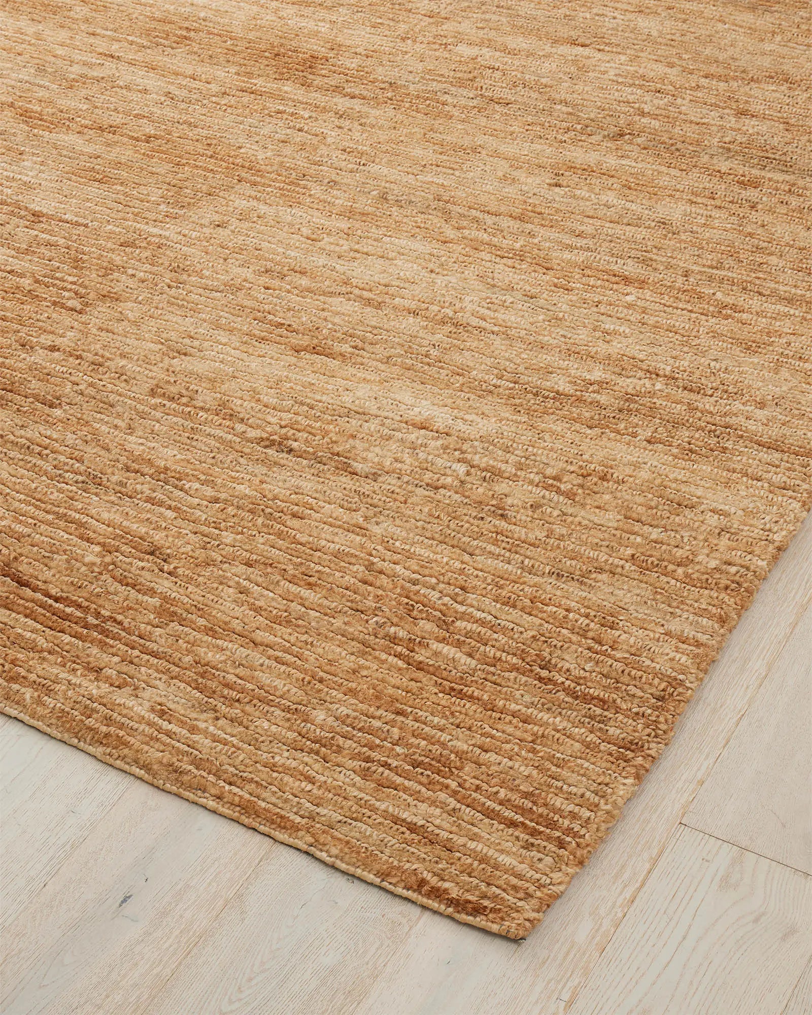 Bastian Natural jute rug corner detail showing linear looped and cut weave texture in golden-brown, by Weave Home