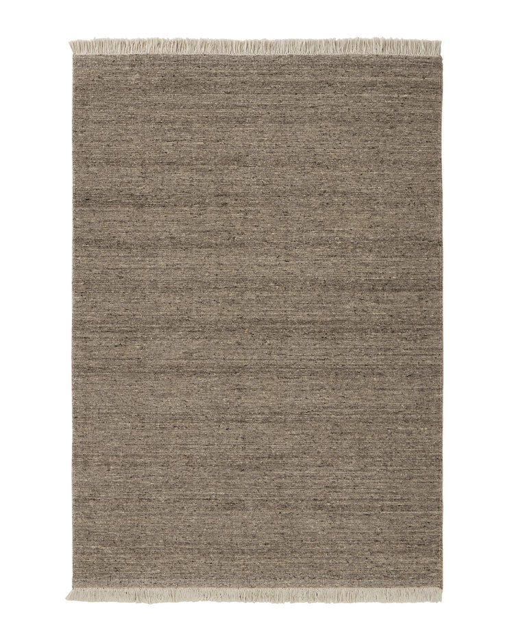 Anton Ash hand-woven wool rug with ribbed texture, grey neutral with warm brown undertones and cream cotton fringe by Weave Home