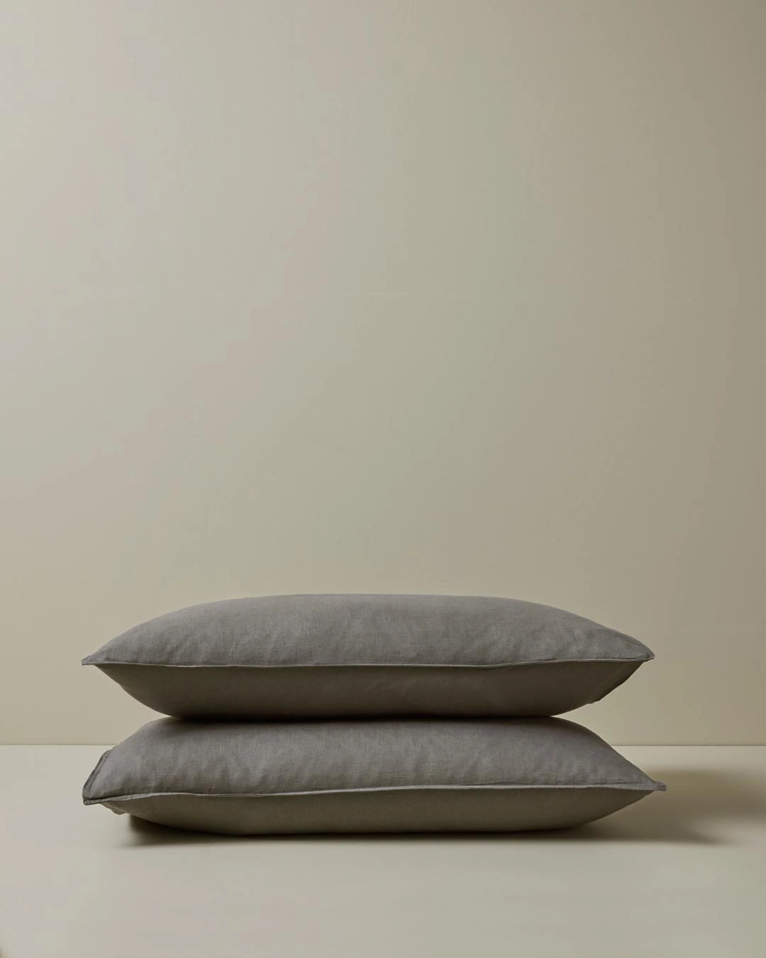 Ravello Pillowcase Set in Charcoal, stacked pair showing top-stitched flanged edge detail, European linen by Weave Home