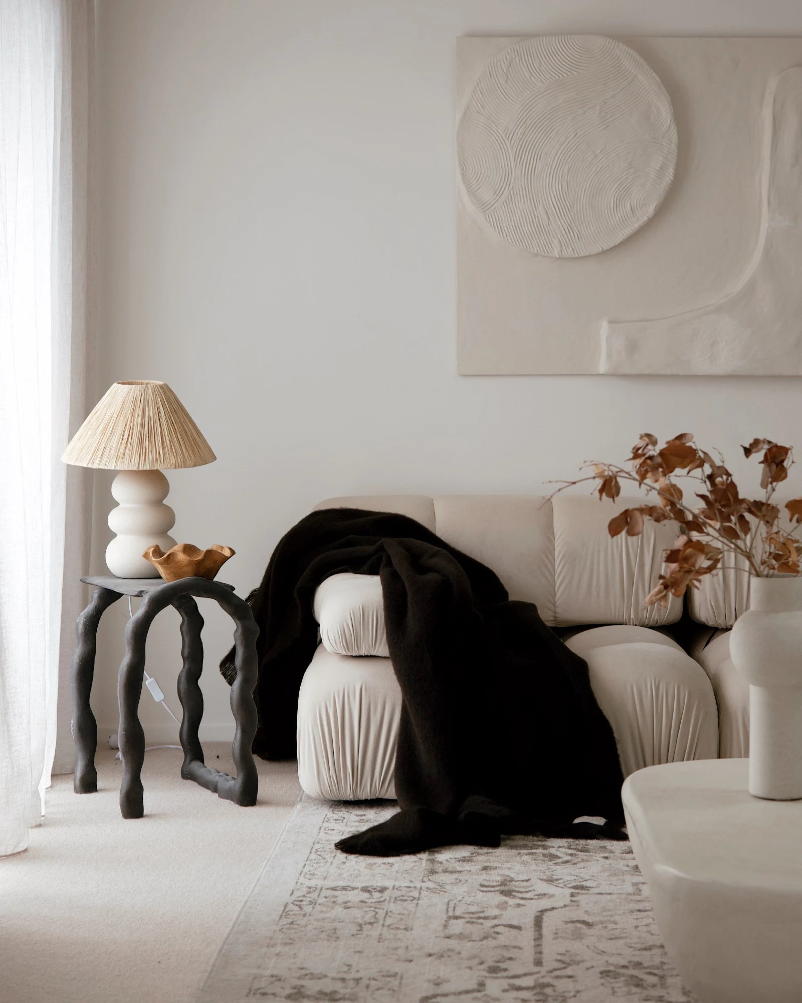Hyde Cocoa wool blend throw in rich dark chocolate, draped over cream sofa with brushed plush finish by Weave Home