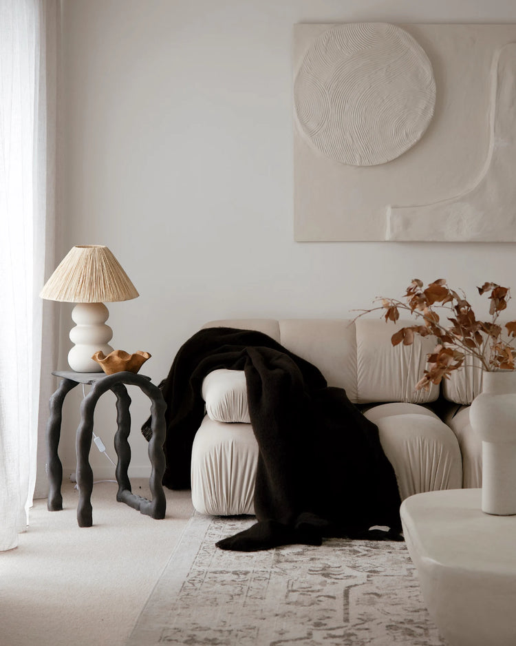 Hyde Cocoa wool blend throw in rich dark chocolate, draped over cream sofa with brushed plush finish by Weave Home
