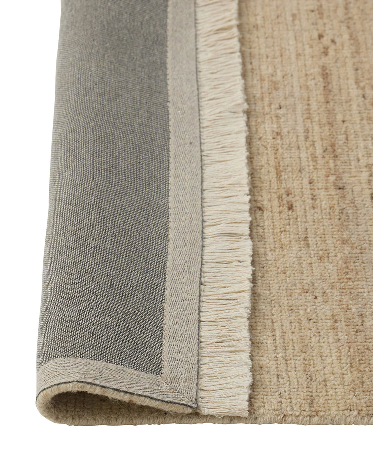 Anton Sand wool rug detail showing cut and loop pile texture with cream cotton fringe border by Weave Home