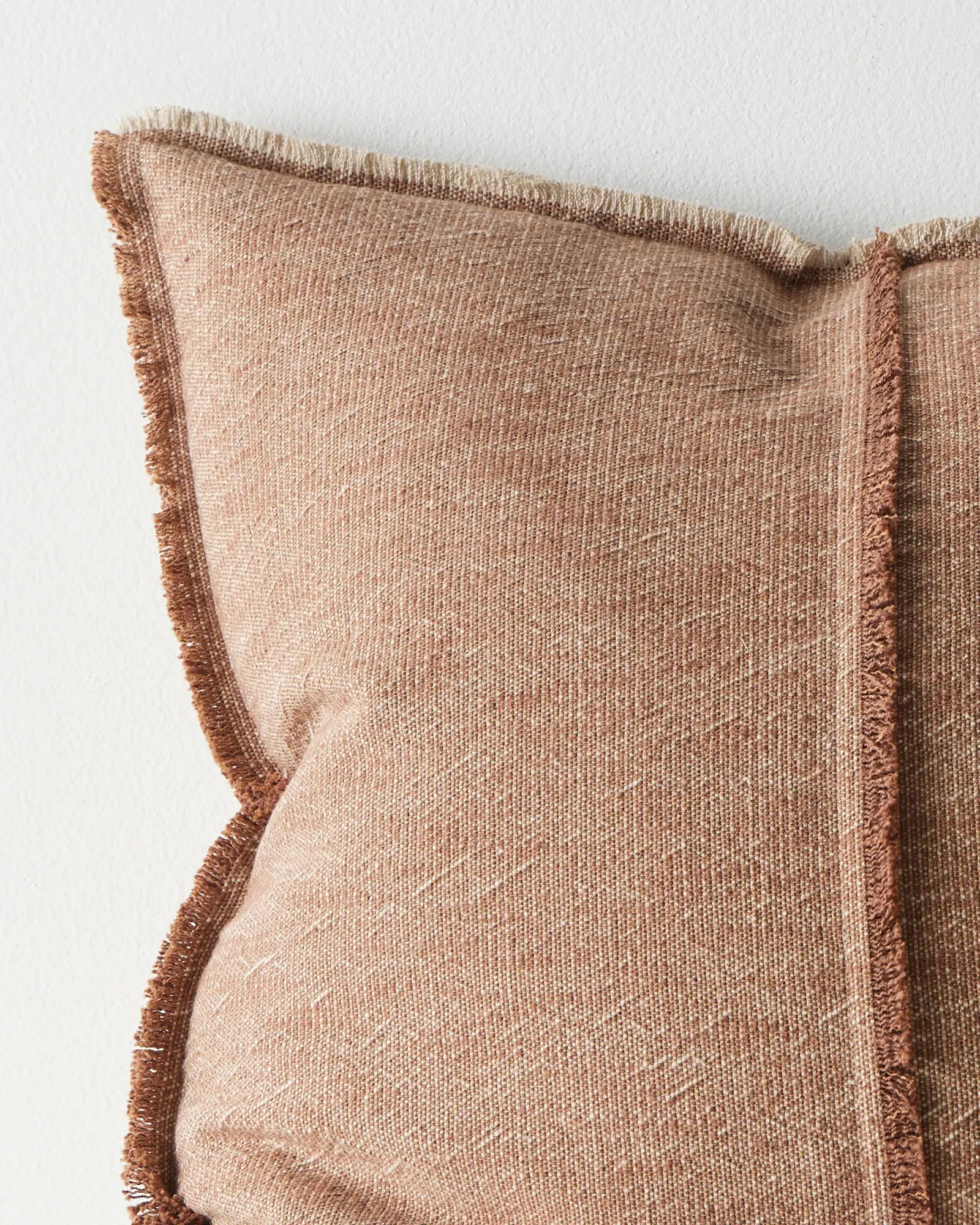 Adela Rust 50x50 cotton linen cushion, close-up of textured two-tone weave with raw-edged fringe border by Weave Home