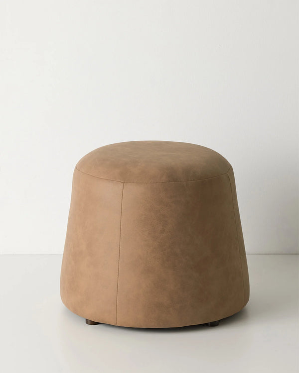 Landro Toffee ottoman, warm brown soft polyester with leather grain texture and domed silhouette, by Weave Home