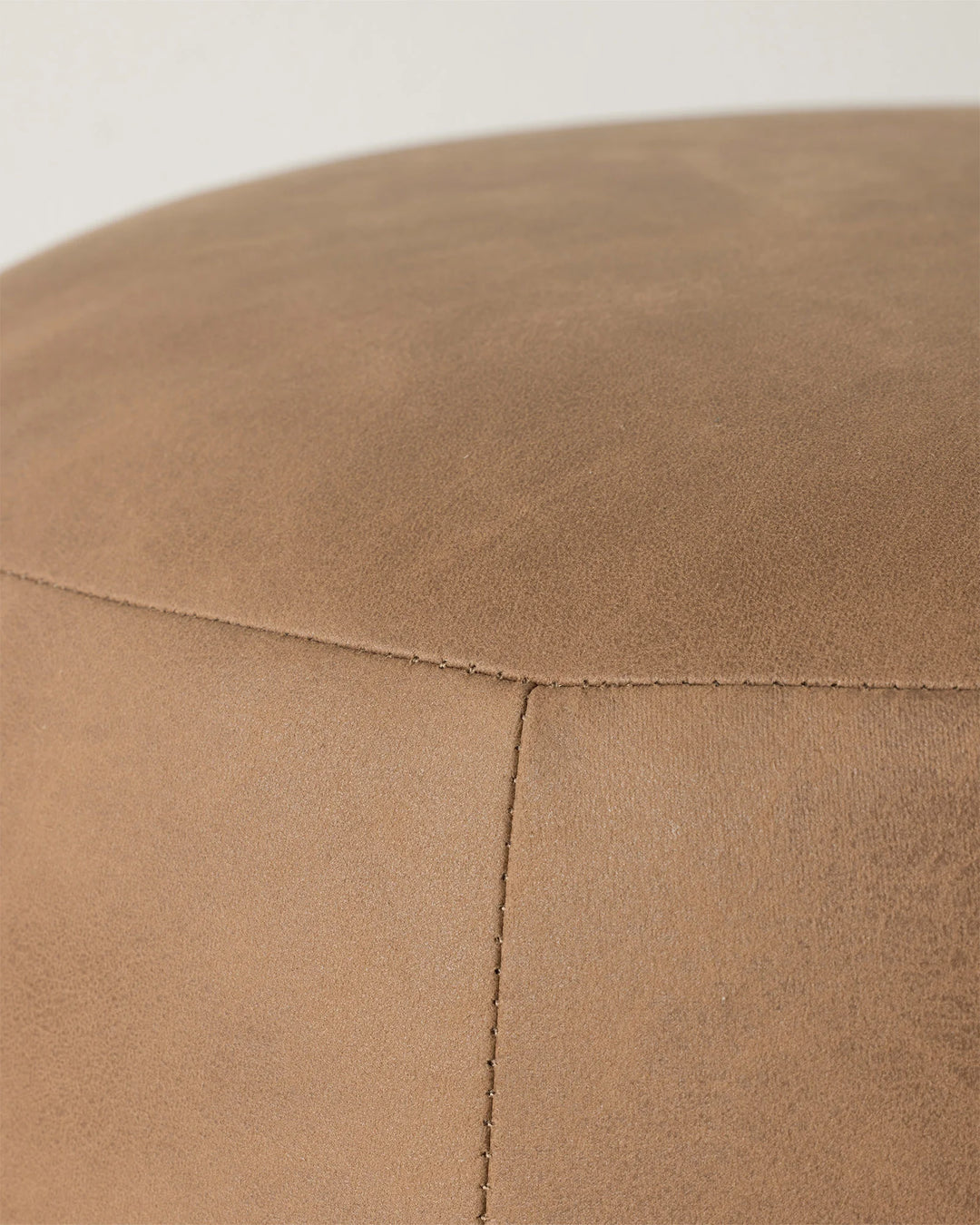 Landro ottoman in toffee, close-up detail of soft polyester leather-look upholstery with subtle grain texture and blanket stitch seam by Weave Home